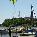 Gemuetliches Dachgeschoss-apartement Mit Seeblick Und Grossem Garten Am Wasser By Interhome